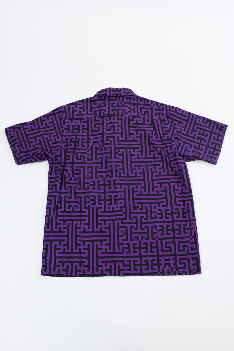 Back view of purple shirt with black maze pattern, short sleeves, flat lay