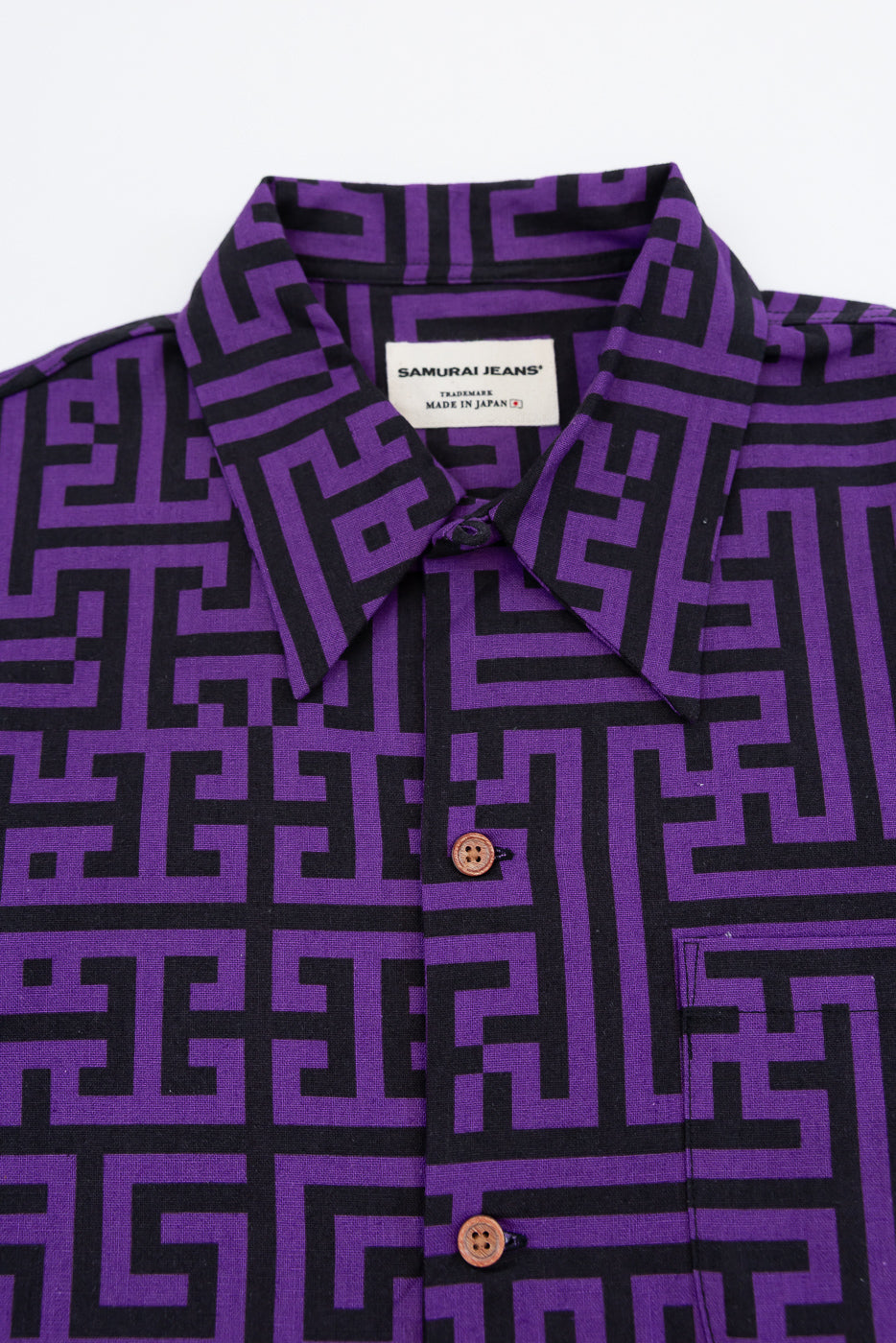 Close-up front view of purple & black geometric pattern shirt, button detail, Samurai Jeans tag, made in Japan