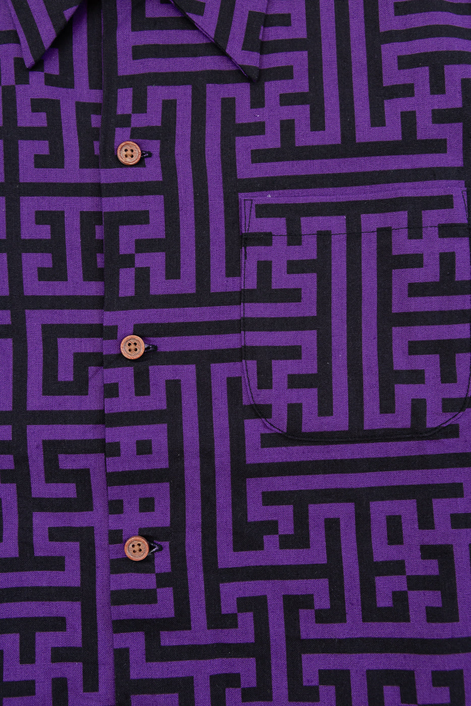 Close-up front view of purple and black geometric pattern shirt with wooden buttons
