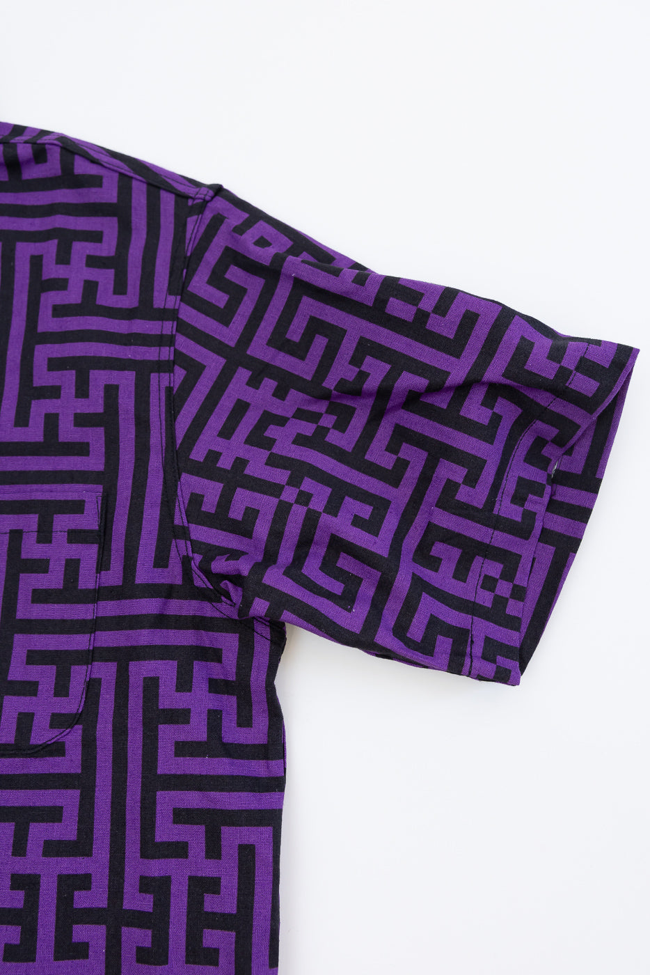 Purple & black geometric pattern shirt, close-up front view showing sleeve and side seam detail
