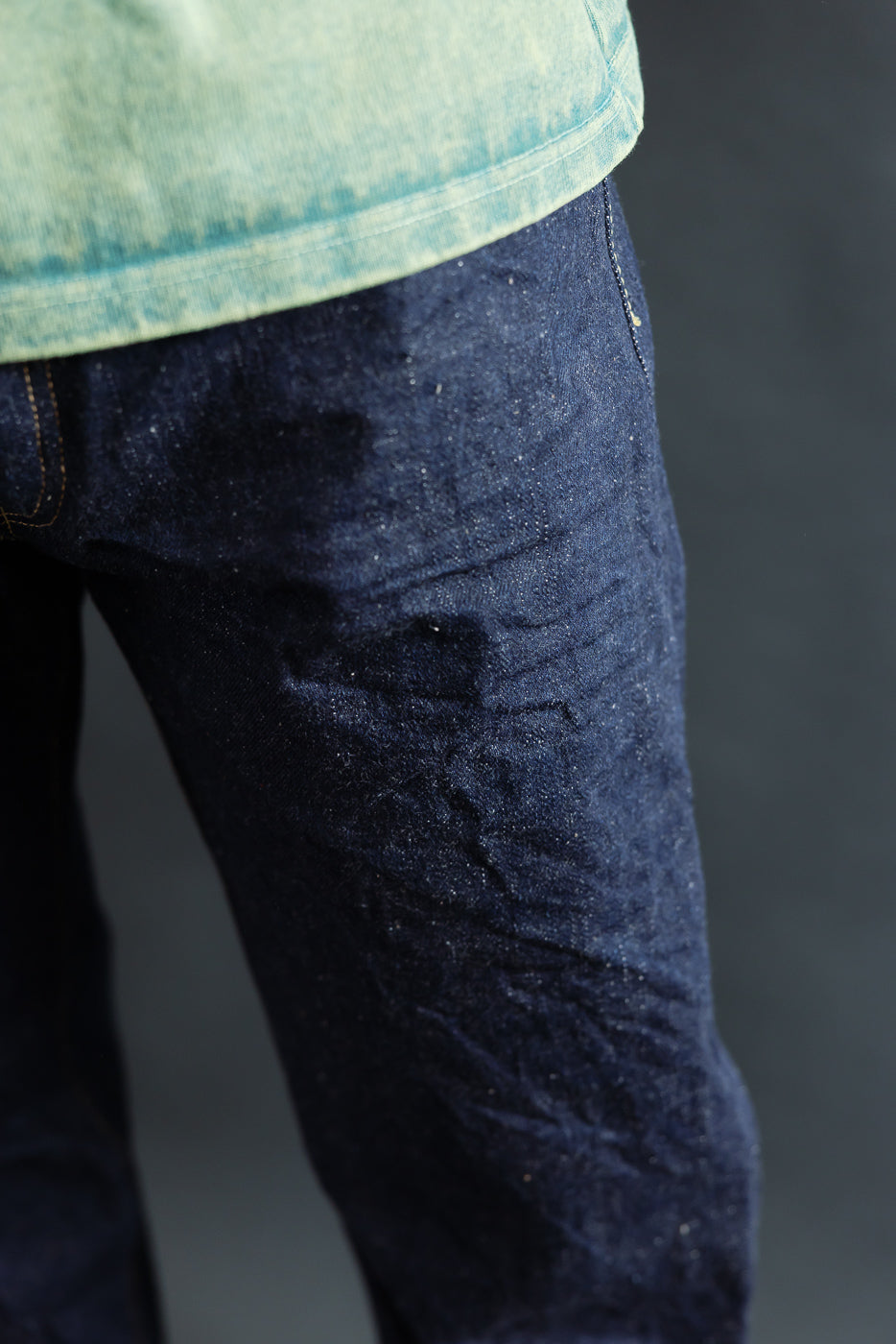 Close-up of front left thigh of selvedge jeans on male model, 5'9