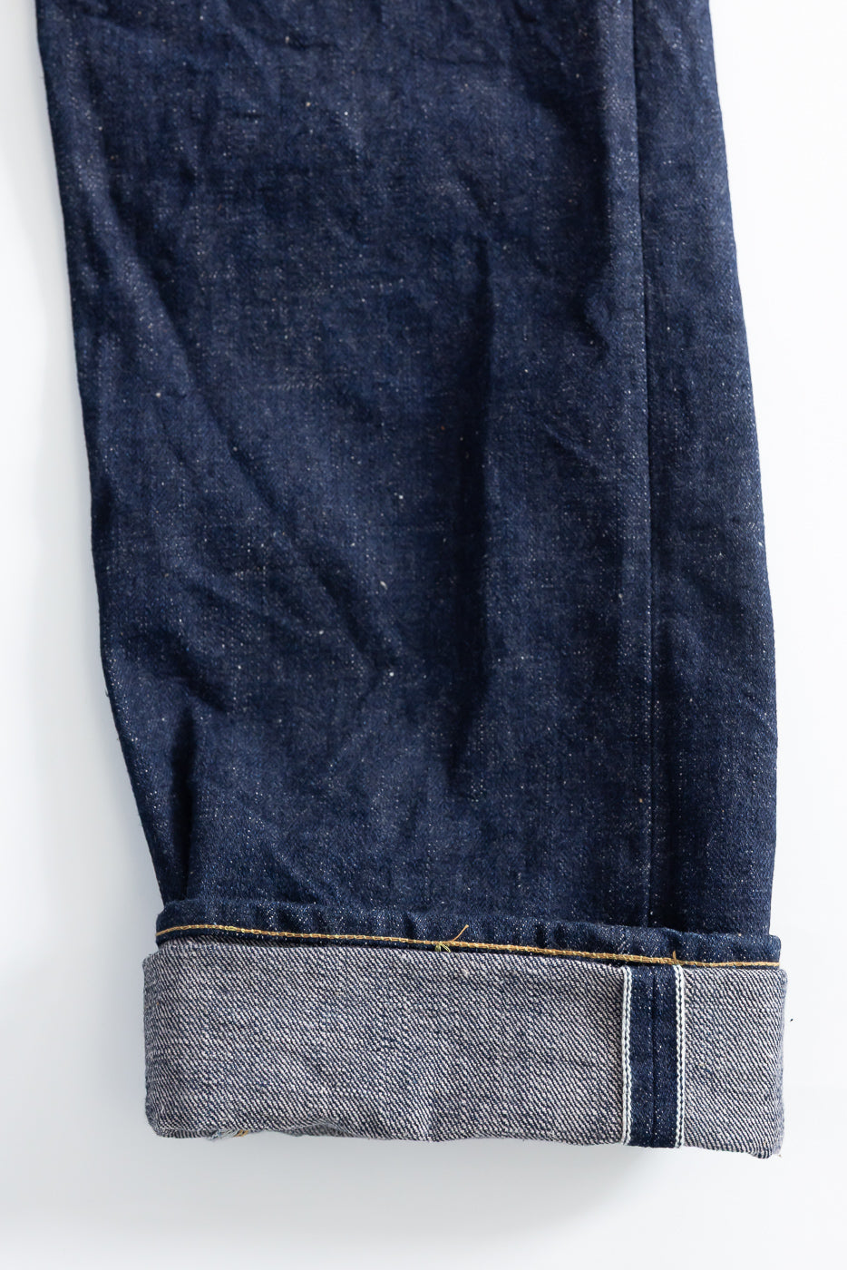 Close-up of cuffed hem, side view, 18oz selvedge denim jeans showing selvedge ID and texture.