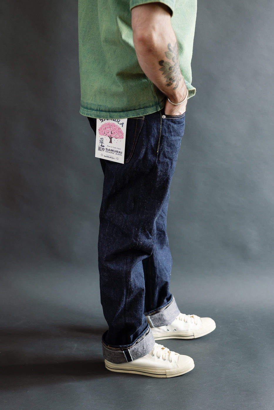 Side view close-up of men's regular straight selvedge jeans on 5'9