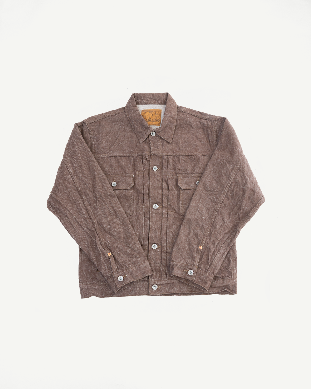 Flat lay front view of brown corduroy work jacket with button closures, chest pockets, and brand tag
