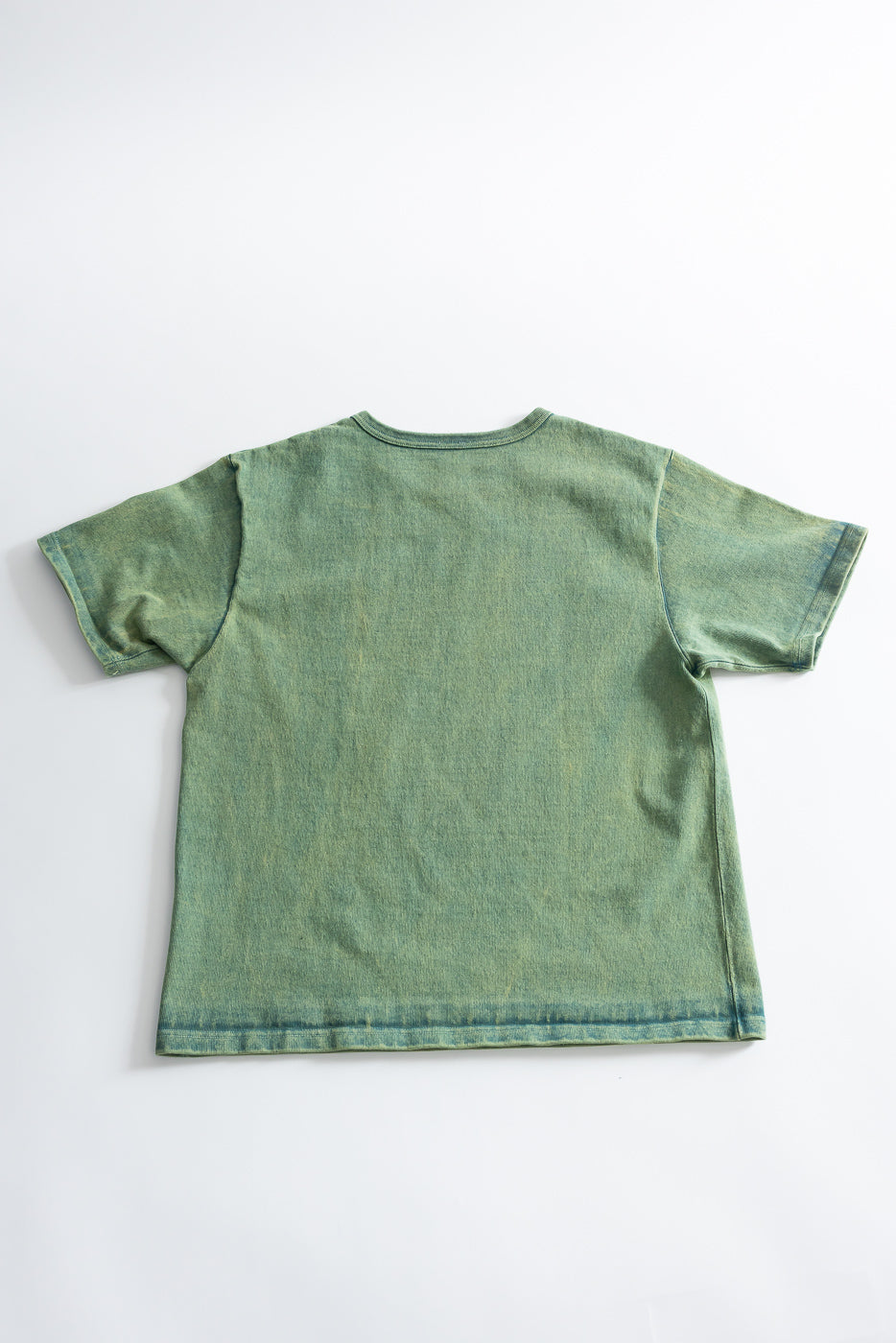 Flat lay of back side of extra heavy green t-shirt, short sleeve, visible fabric texture.