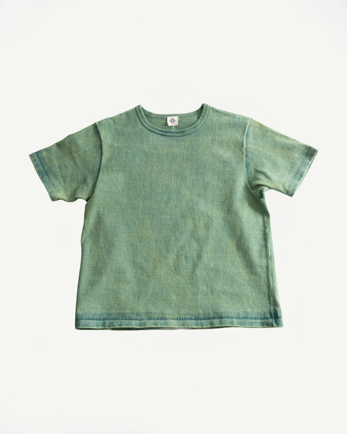 Flat lay of green extra heavy T-shirt front, showing fabric texture and ribbed crew neck.