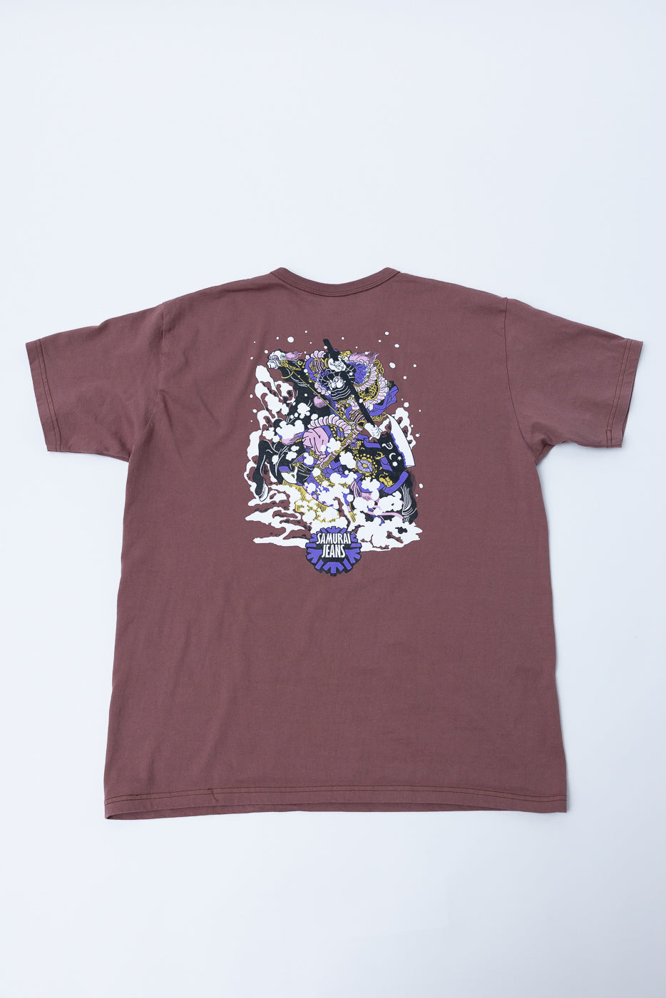 Back view of maroon t-shirt with Samurai Jeans graphic print, flat lay
