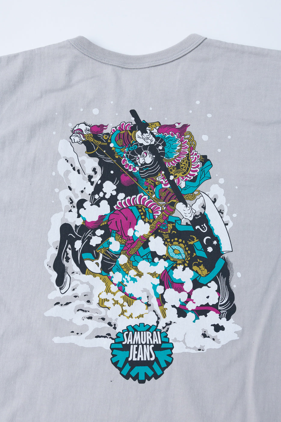 Gray t-shirt back view with colorful samurai graphic and 'Samurai Jeans' logo, flat lay
