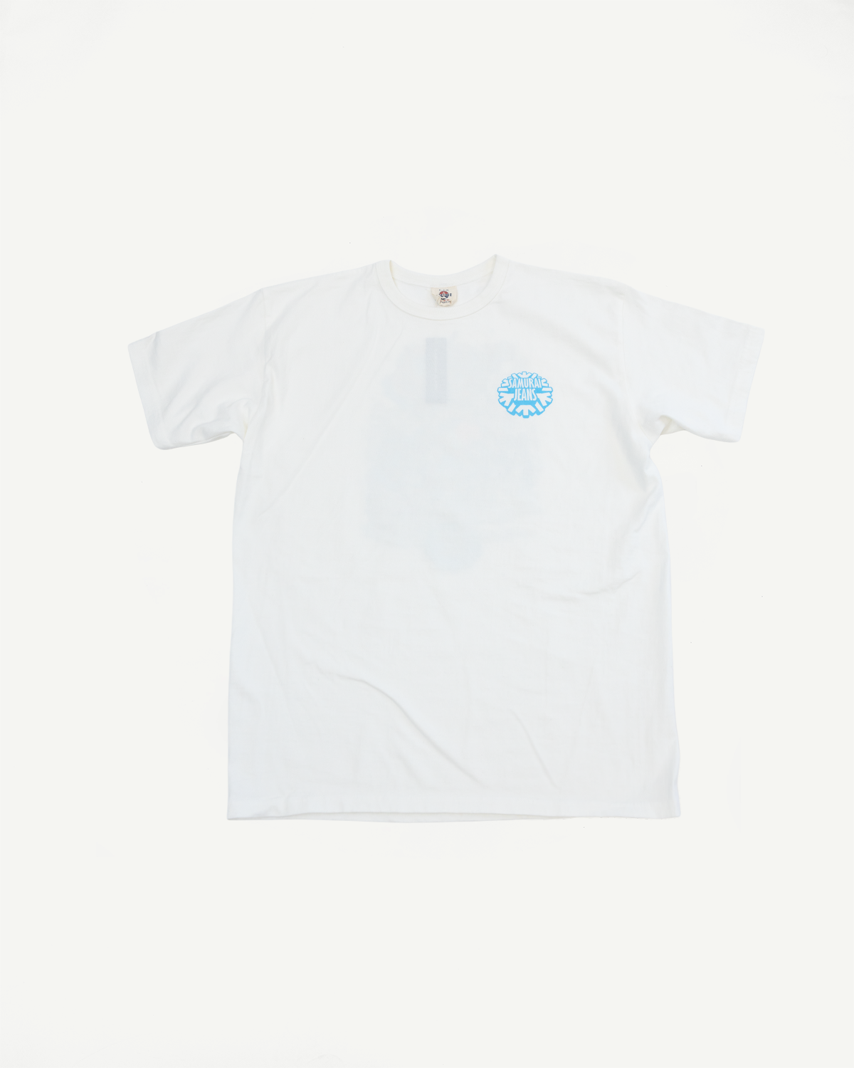 White t-shirt flat lay front view, light blue Samurai Jeans logo, crew neck, short sleeves