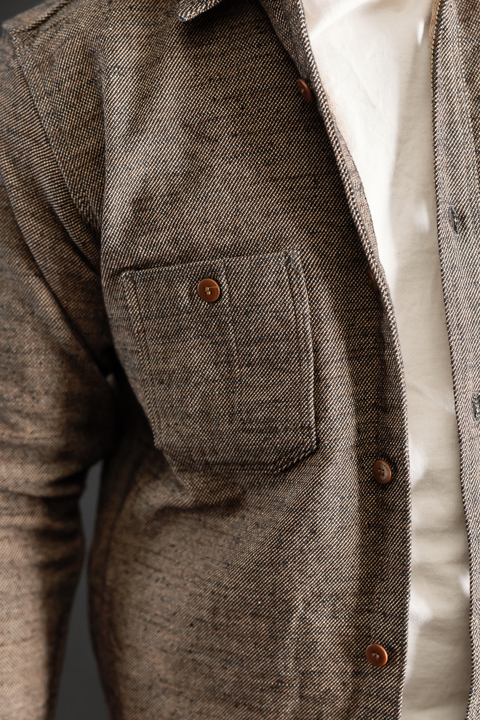 Close-up front of Samurai Elemental black flannel shirt, chest pocket, brown buttons, male model 5'9