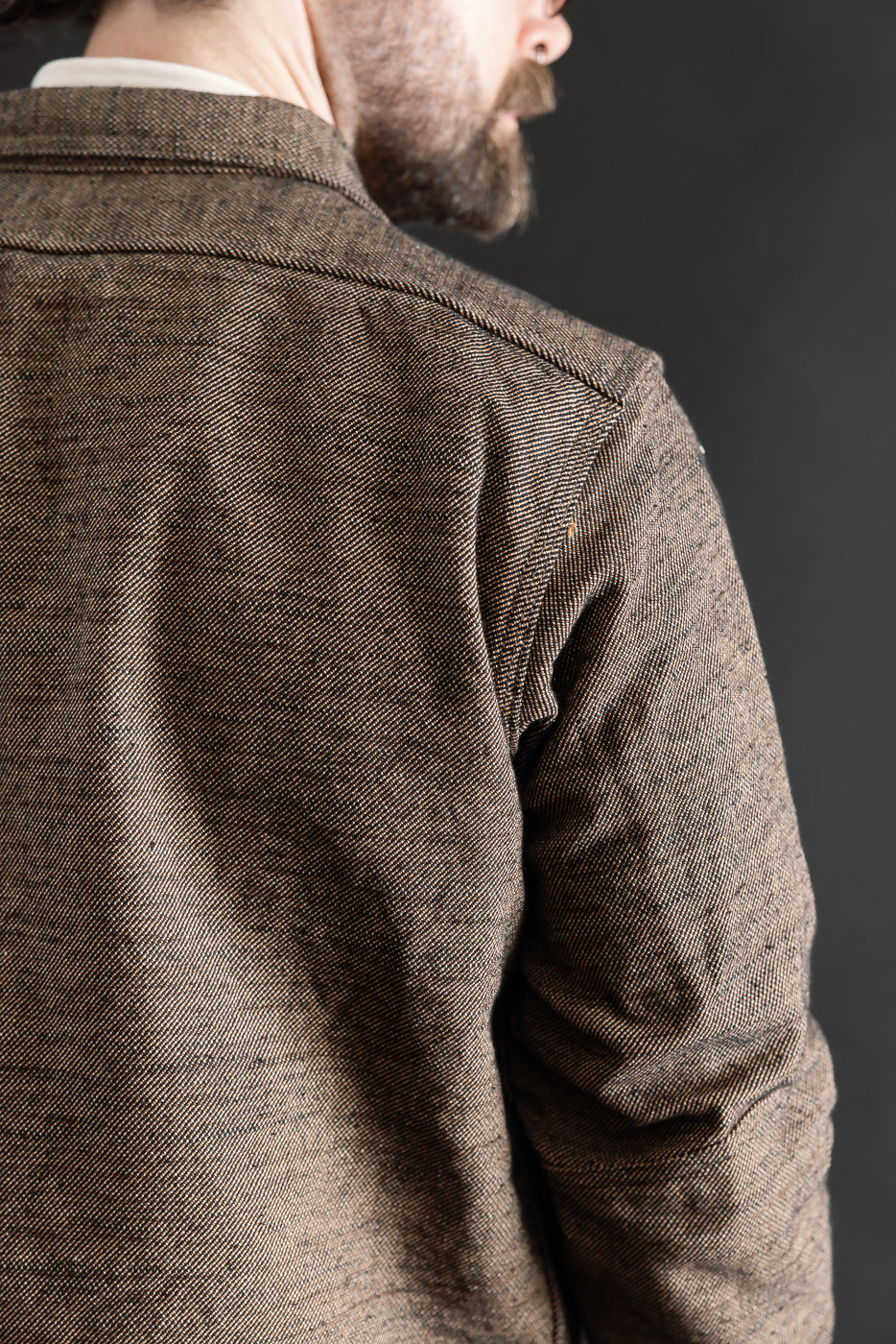 Close-up back view of Samurai Elemental flannel shirt on male model, showing fabric texture.