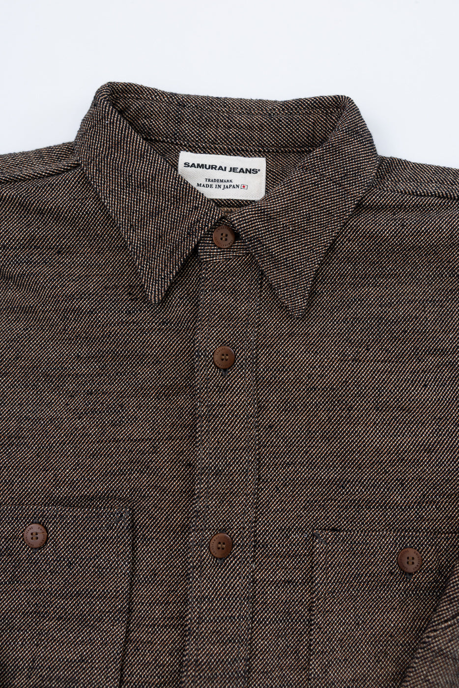 Close-up of Samurai Jeans elemental flannel shirt front, showing collar, buttons, and chest pockets.