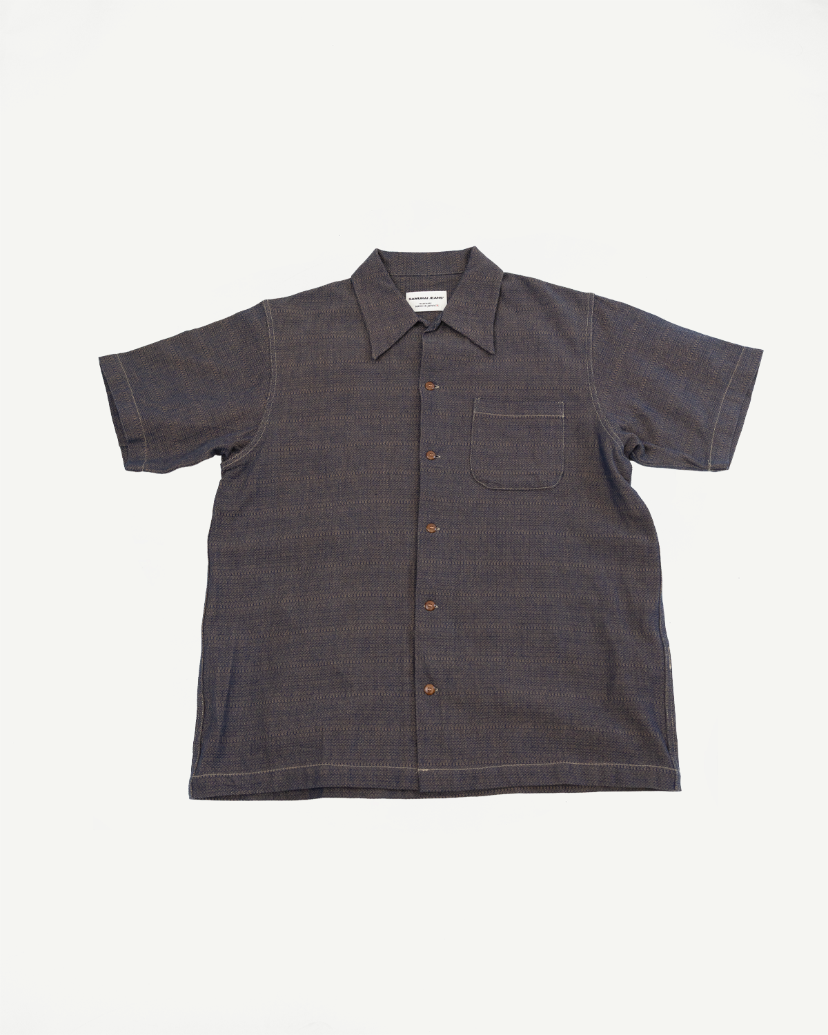 Front flat lay of men's short-sleeve button-up shirt with chest pocket, textured fabric, and contrast stitching