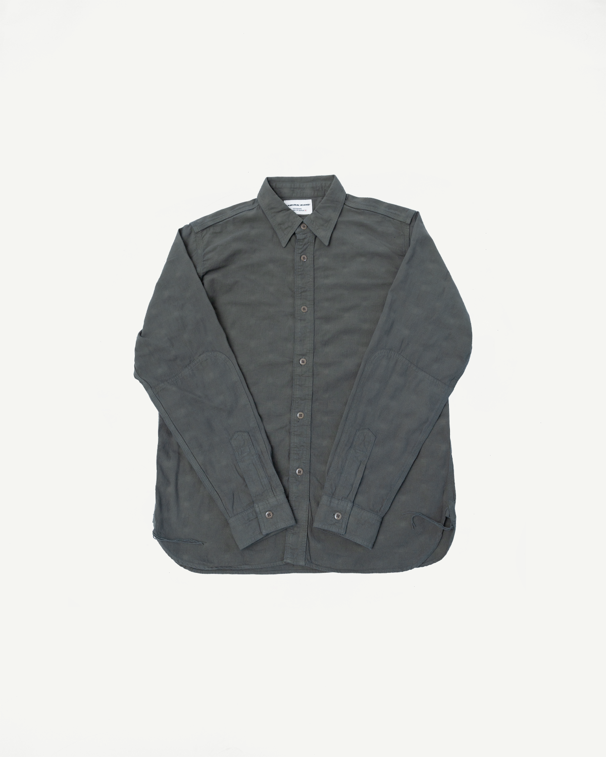SSS25-ATW Tropical Weather Dobby Shirt features a charcoal long-sleeve design with button-front, crafted from textured Japanese Panama-weave dobby cloth, showcasing reinforced elbow patches.