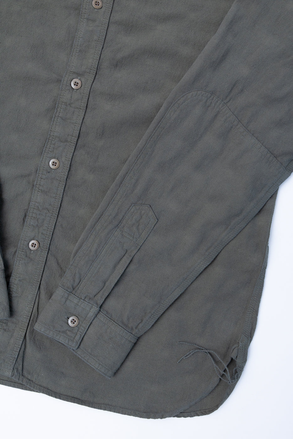 SSS25-ATW Tropical Weather Dobby Shirt in muted olive-gray, featuring a button-front, barrel cuff, and curved hem, showcasing its textured Panama-weave fabric.