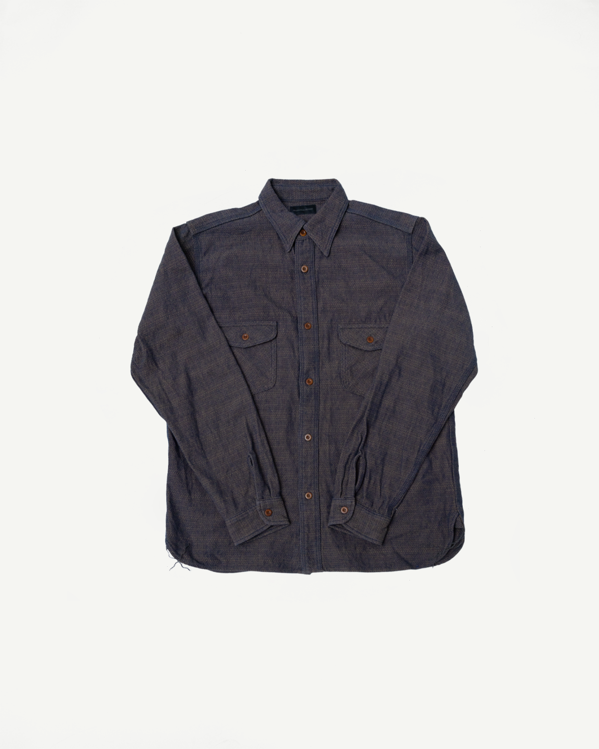 Dark indigo selvedge work shirt flat lay, front view, button-down collar, two chest pockets, long sleeves, textured fabric