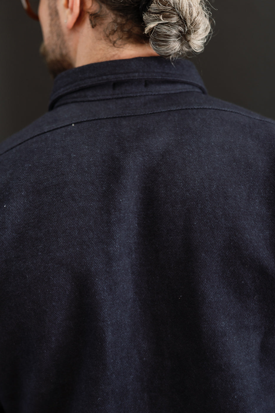 Back view close-up of navy wool shirt on male model, 5'9