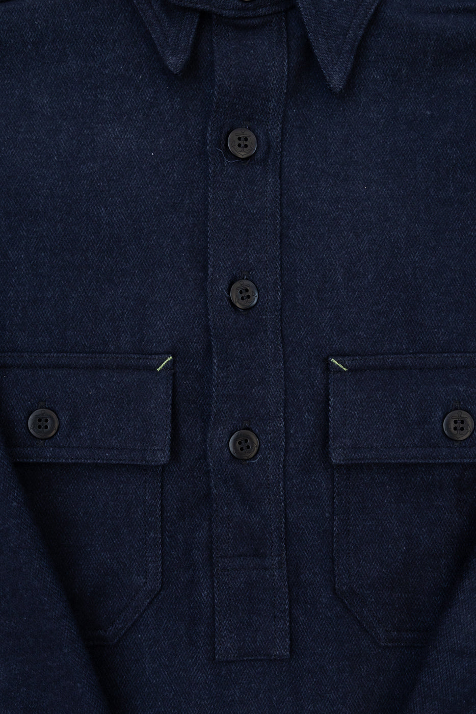 Close-up front view of dark navy work shirt with button-down collar, two chest pockets, and contrast stitching details.
