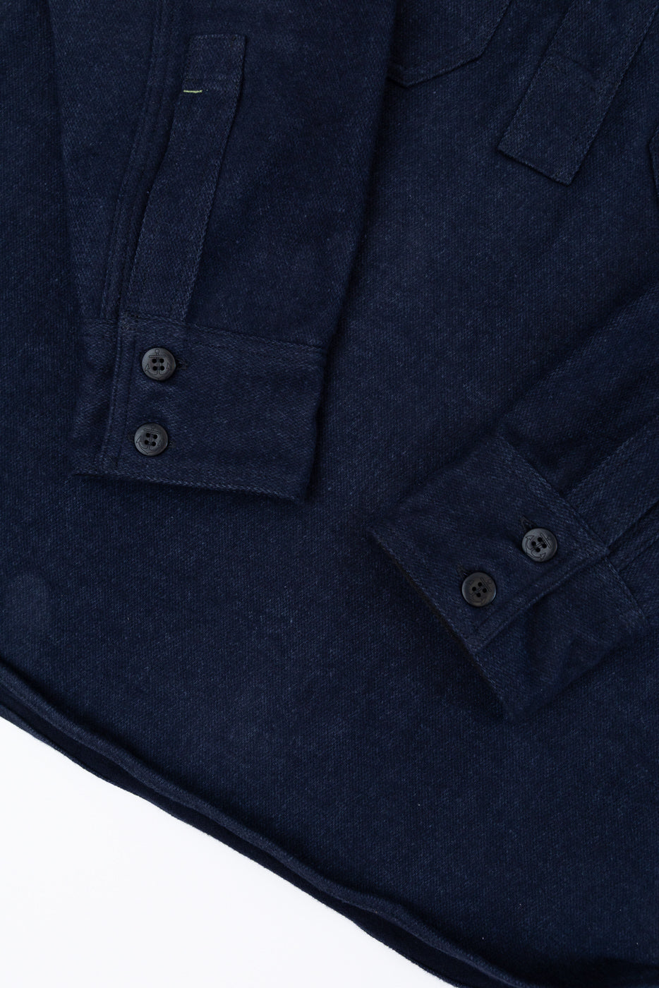 Close-up front view of dark navy shirt showing chest pocket, button details, and fabric texture