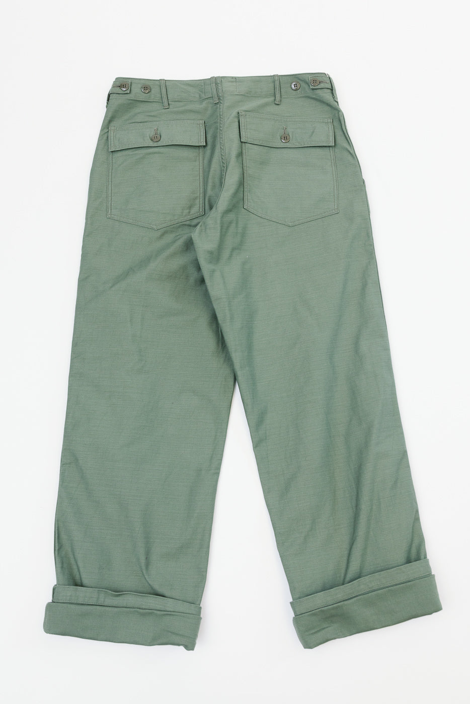 Back view of olive green cargo pants with buttoned pockets, cuffed hems, and belt loops on flat lay