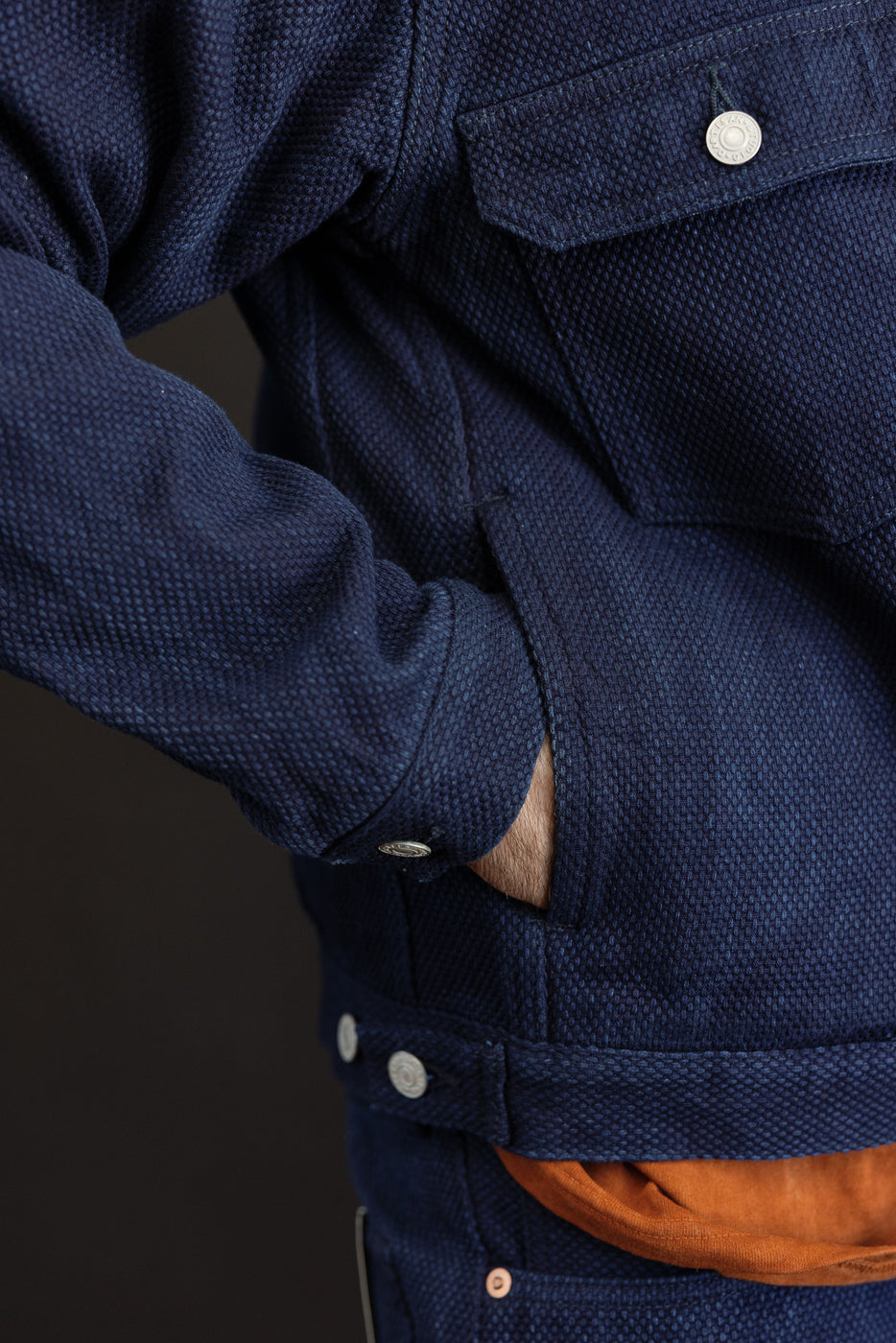 Close-up side view of navy blue textured jacket, male model 5'9