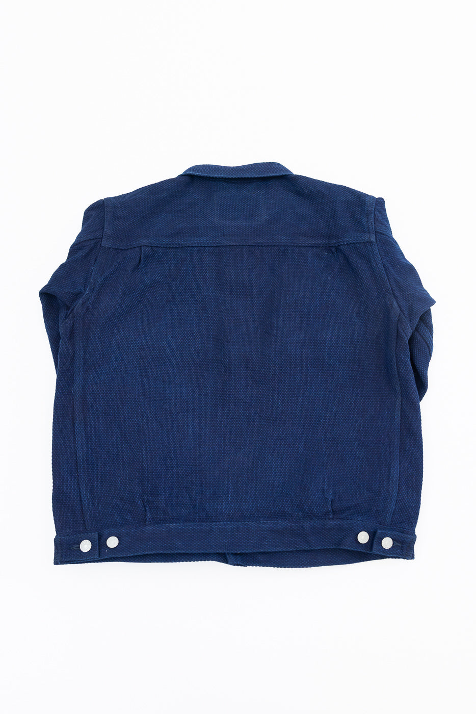 Back view flat lay of navy blue textured jacket with buttoned hem, no model