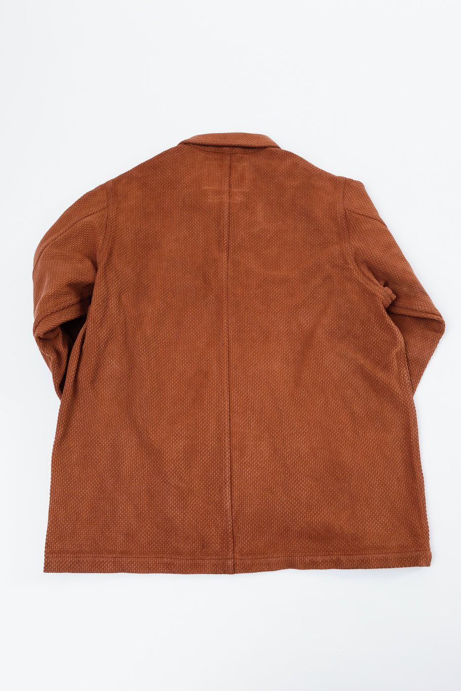 Flat lay back view of a rust-brown textured fabric jacket with a pointed collar.
