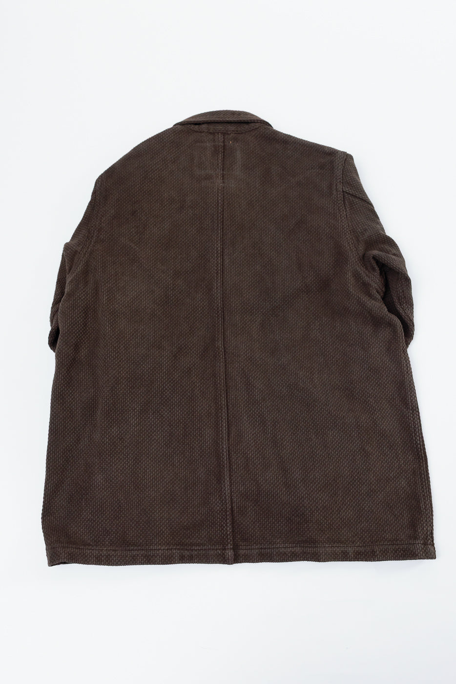 Back view of a brown textured corduroy jacket flat lay.