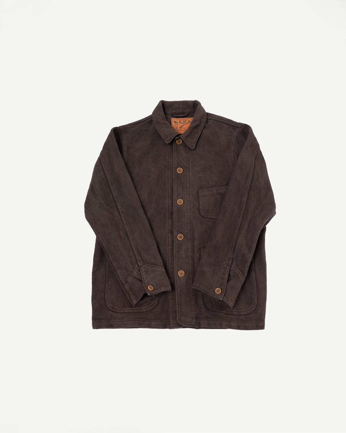 Front view flat lay of a dark brown corduroy button-up chore jacket.