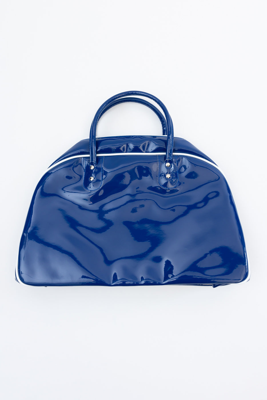 Front view of glossy blue dome-shaped handbag with white trim and dual handles