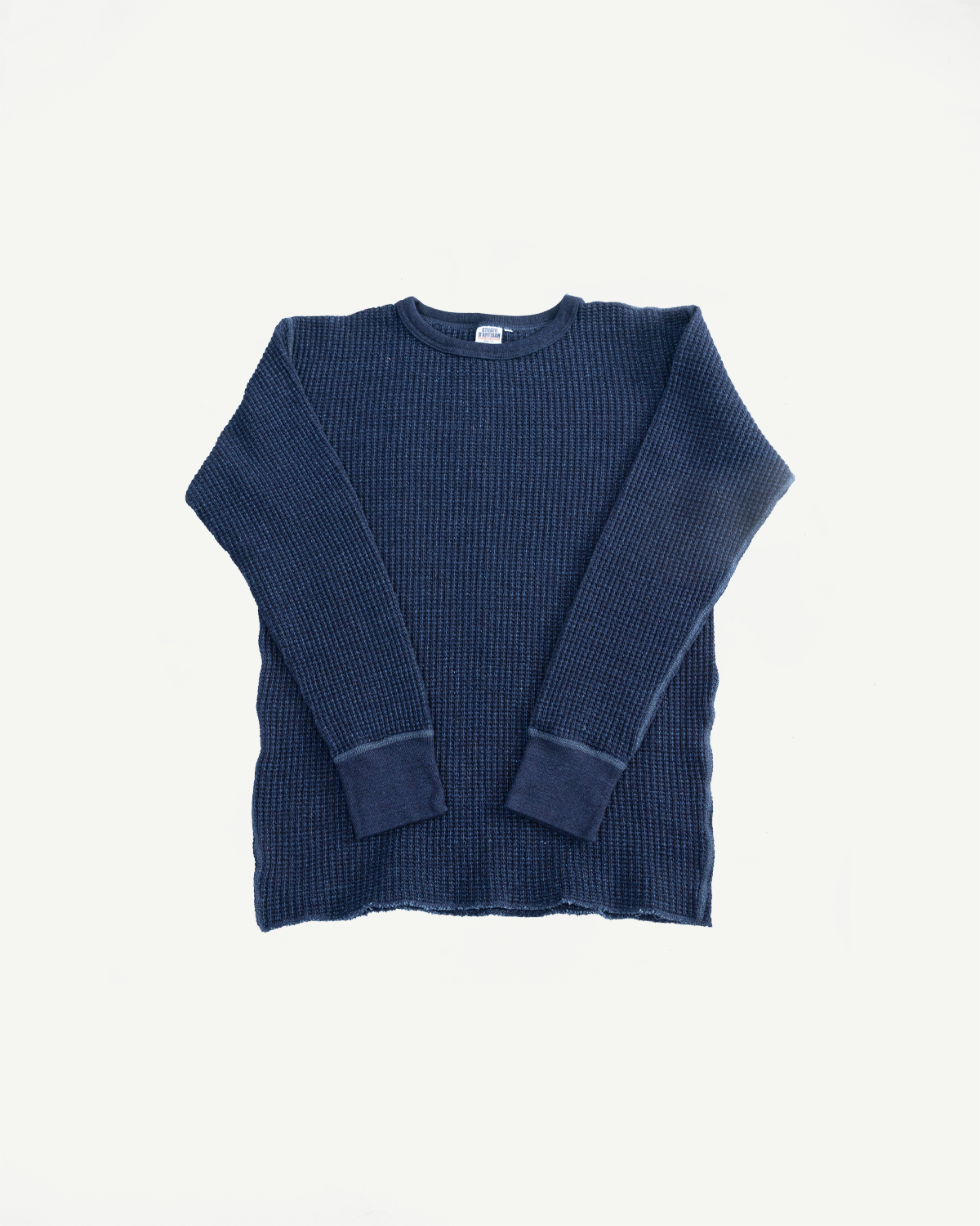 Flat lay of indigo-dyed heavy waffle thermal shirt, front view, long sleeves, ribbed cuffs.