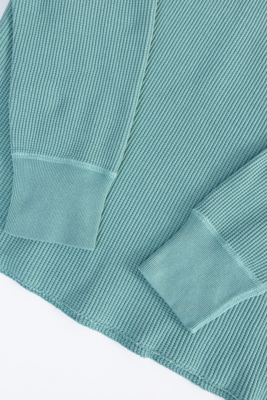 Close-up of Studio D'Artisan 9937 heavy thermal Henley in emerald, showing front sleeve cuffs and ribbed fabric texture.