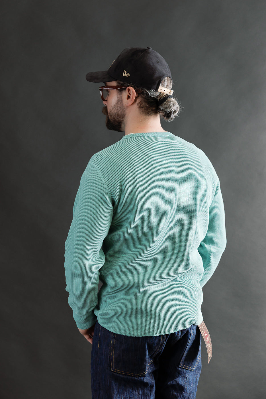 Back view of male model 5'9 165lbs athletic build in emerald Studio D'Artisan heavy thermal long sleeve henley, showing ribbed fabric texture, casual fit, at Dant apparel shop