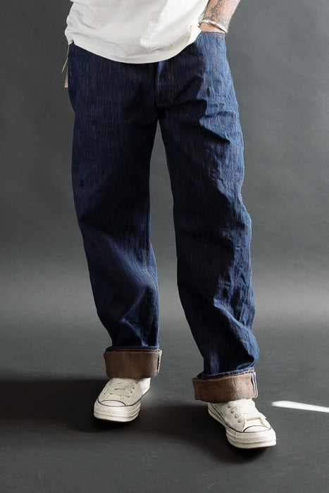 Male model 5'9, 165lbs wearing Studio D'Artisan D1950S indigo kakishibu selvedge jeans, front full body view, regular straight fit, cuffed hem, casual style at Dant.