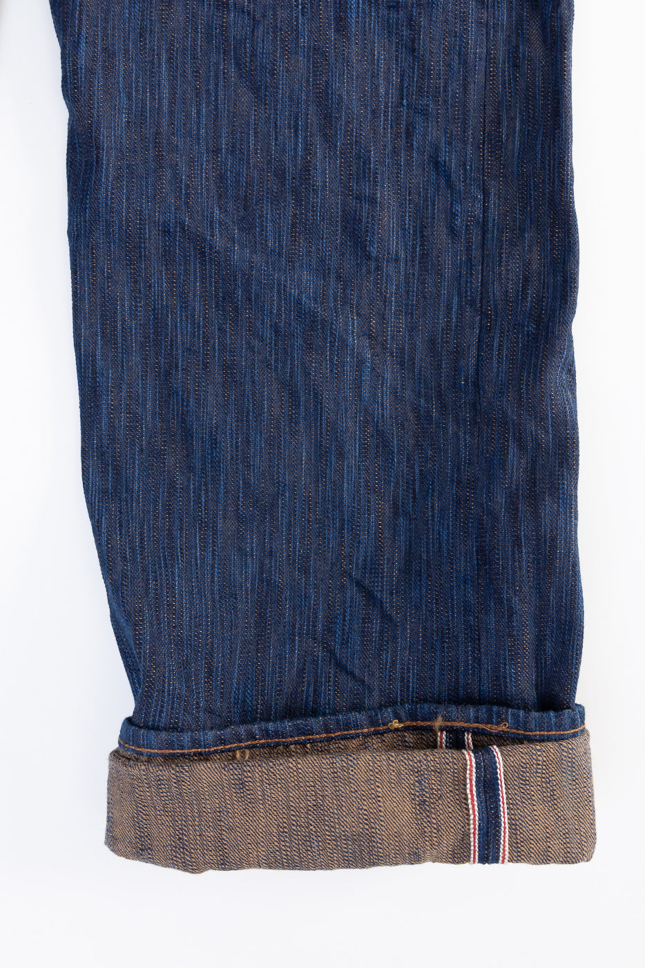 Close-up of Studio D'Artisan D1950S selvedge jeans leg, front side, showing cuff and indigo texture.