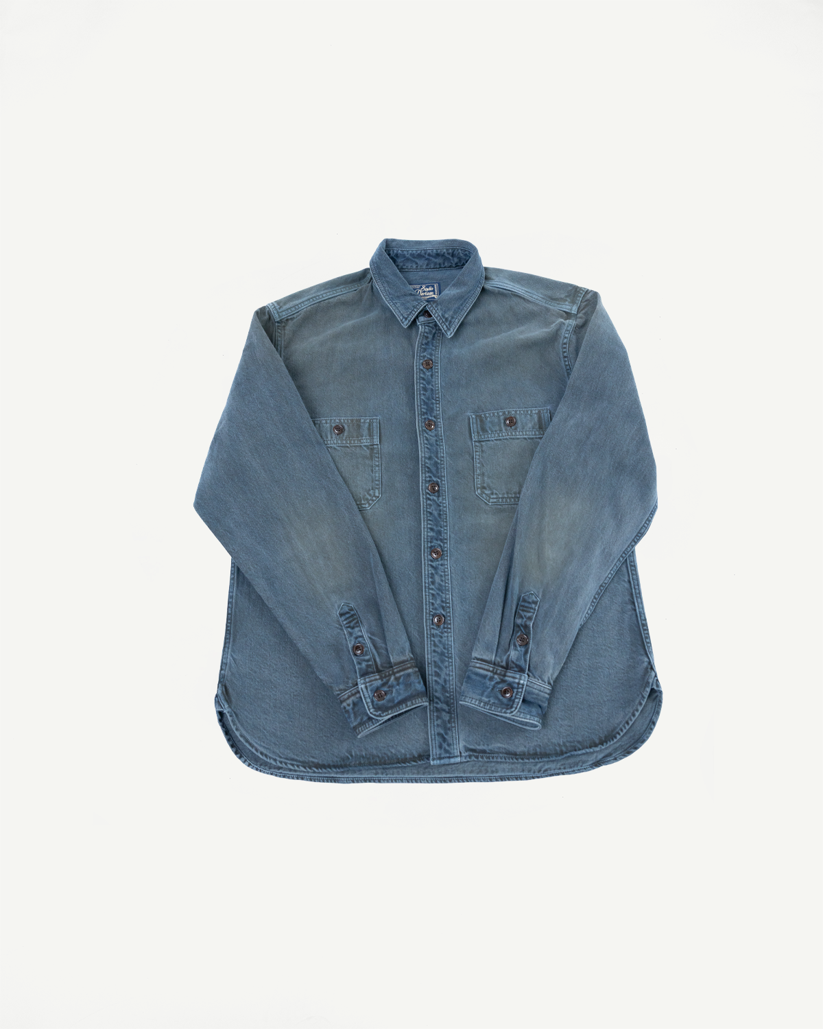 Front view flat lay of a blue denim button-down shirt with chest pockets.