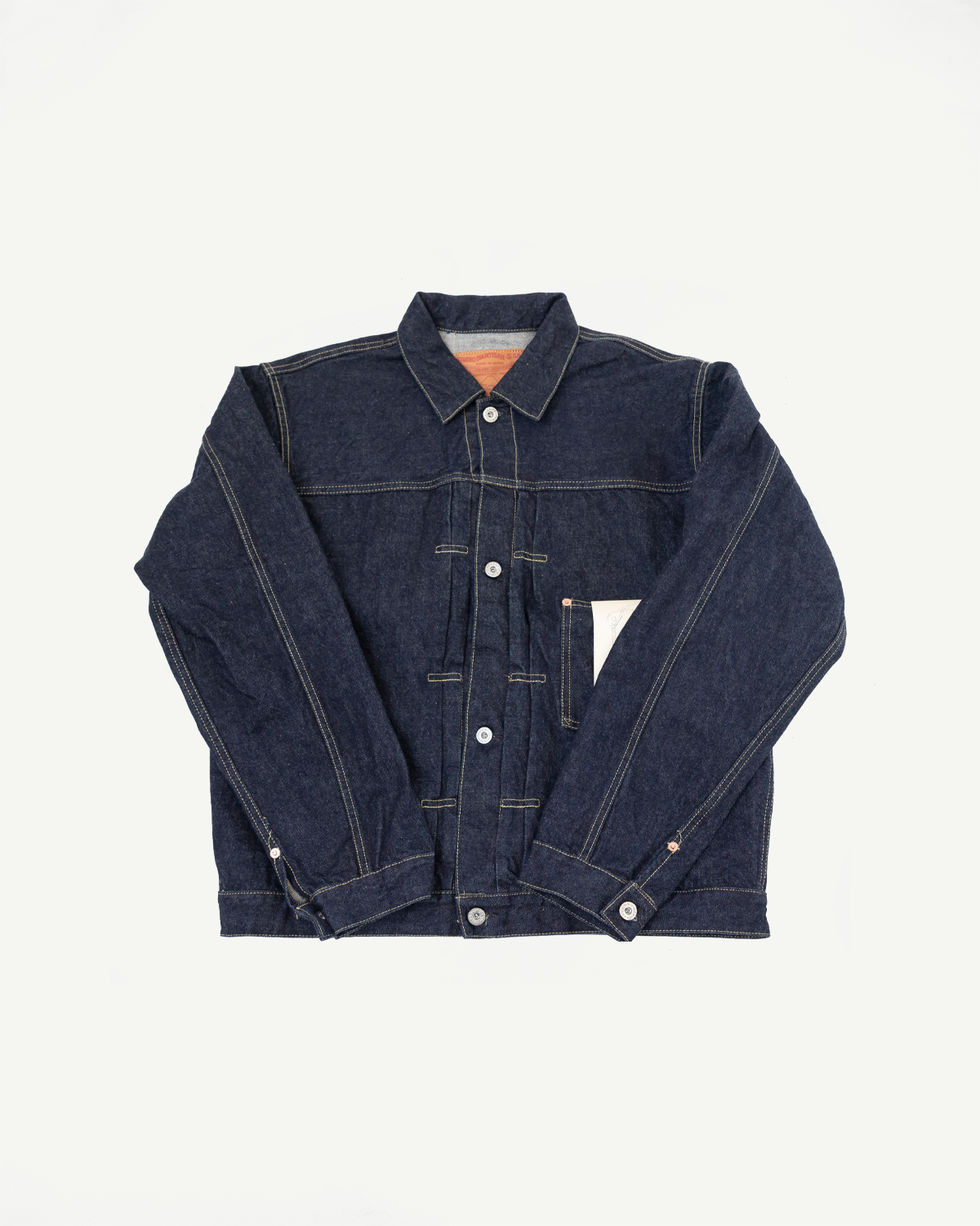 Front flat lay of dark selvedge denim jacket with button closure, chest pocket, and contrast stitching
