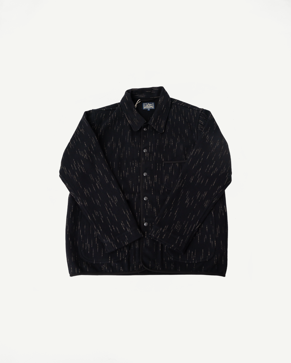 Front flat lay of Studio D'artisan Kasuri dyed black beach cloth coverall, showing collar, chest pocket, and button details.