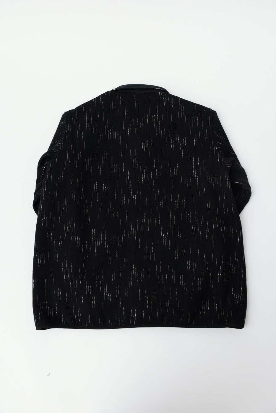 Flat lay of Studio D'Artisan kasuri-dyed beach cloth coverall in black, back view, showing fabric texture detail.