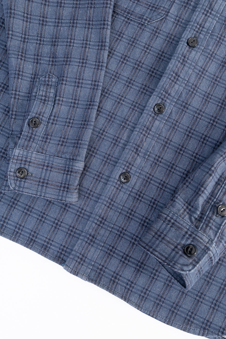 Close-up of navy jacquard check work shirt front, highlighting textured fabric and buttons