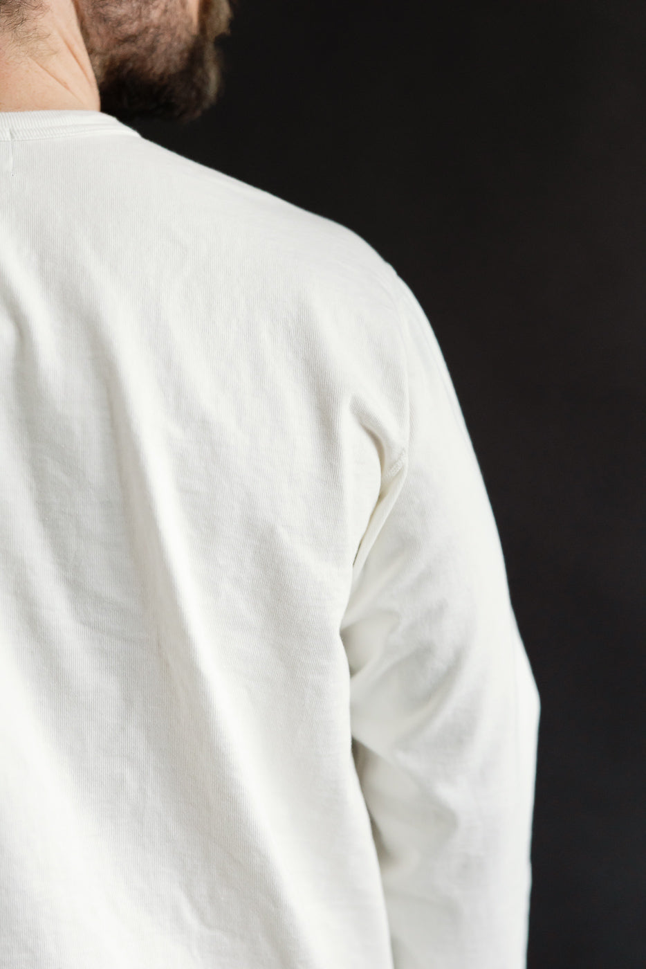 Close-up back view of Studio D’Artisan 8187 Suvin Gold LS Henley white shirt on male model, showcasing shoulder seam and fabric texture.