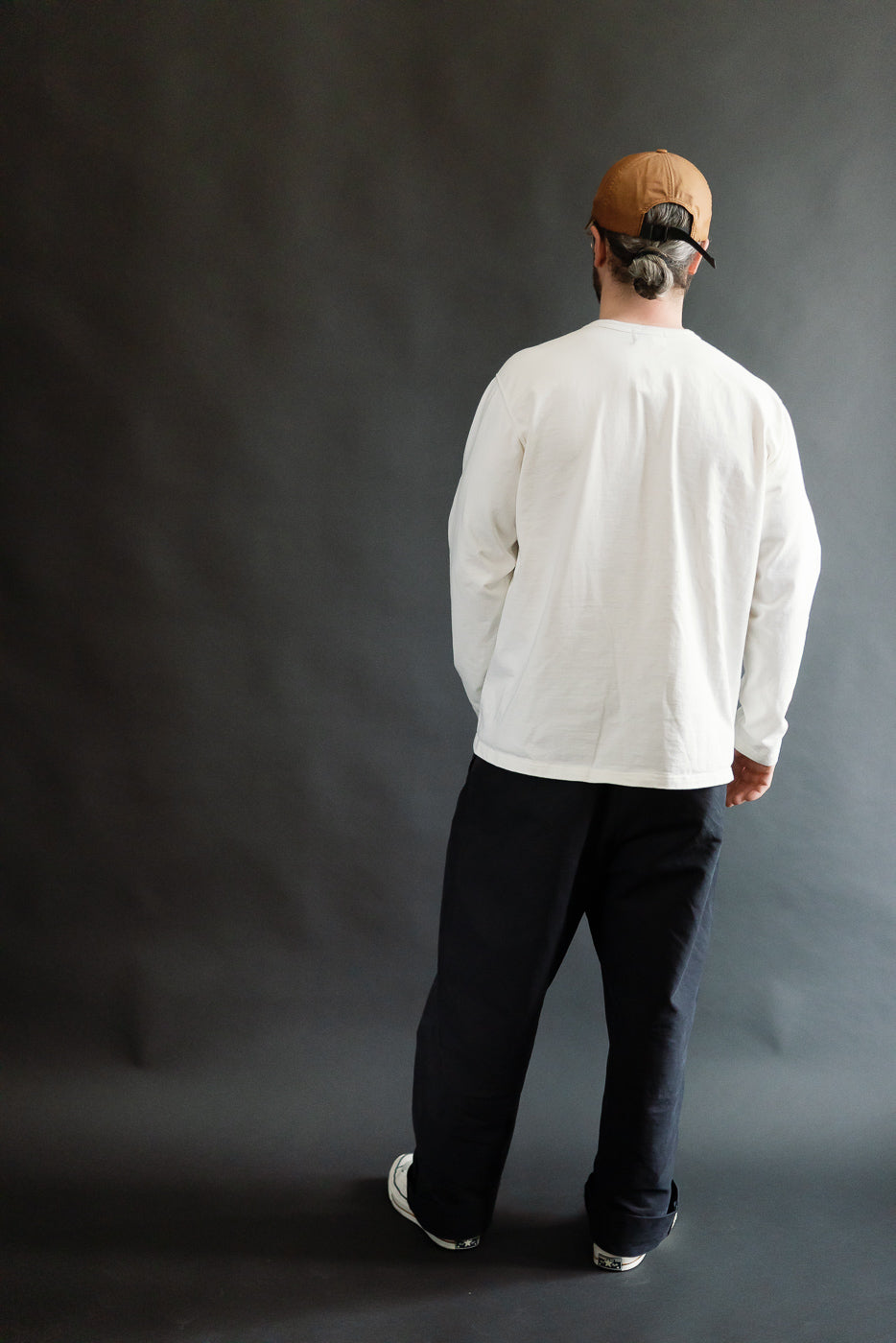 Back view full body of male model 5'9 165lbs in white Studio D'Artisan Suvin Gold LS henley, casual fit, Dant