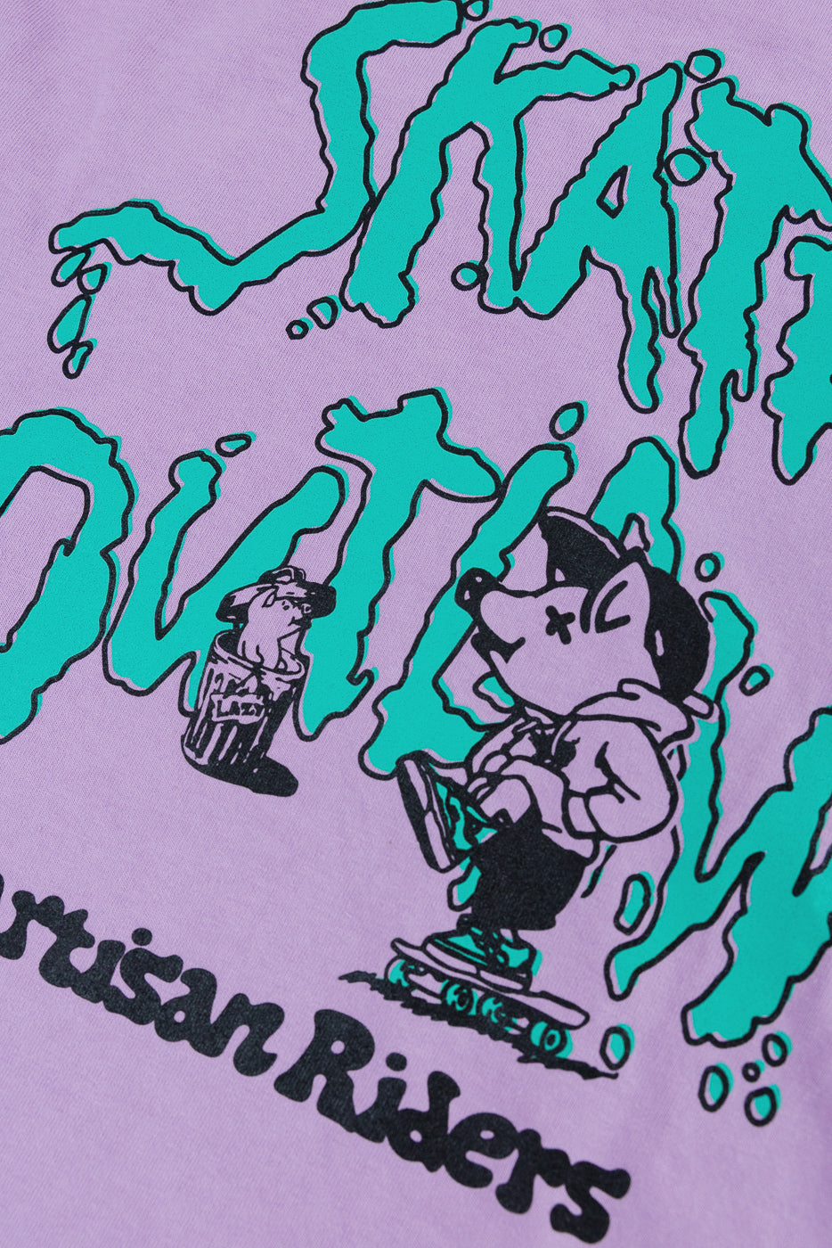 Close-up of purple tee front, green graphic, cartoon skater, 'Artisan Riders' text