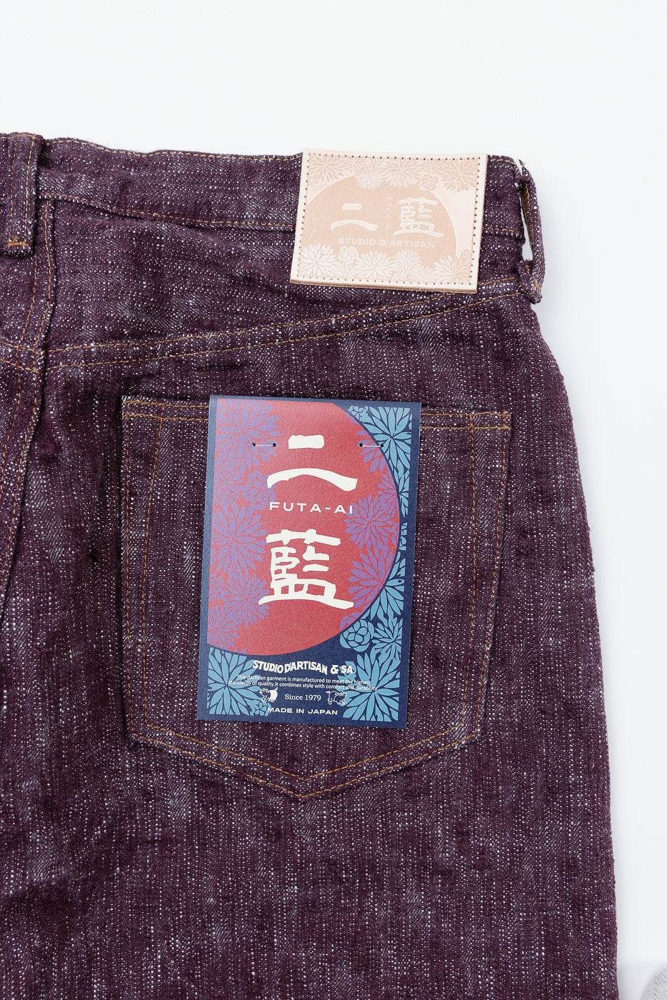 Close-up of back pocket with FUTA-AI tag, showcasing selvedge denim texture and Japanese craftsmanship details.
