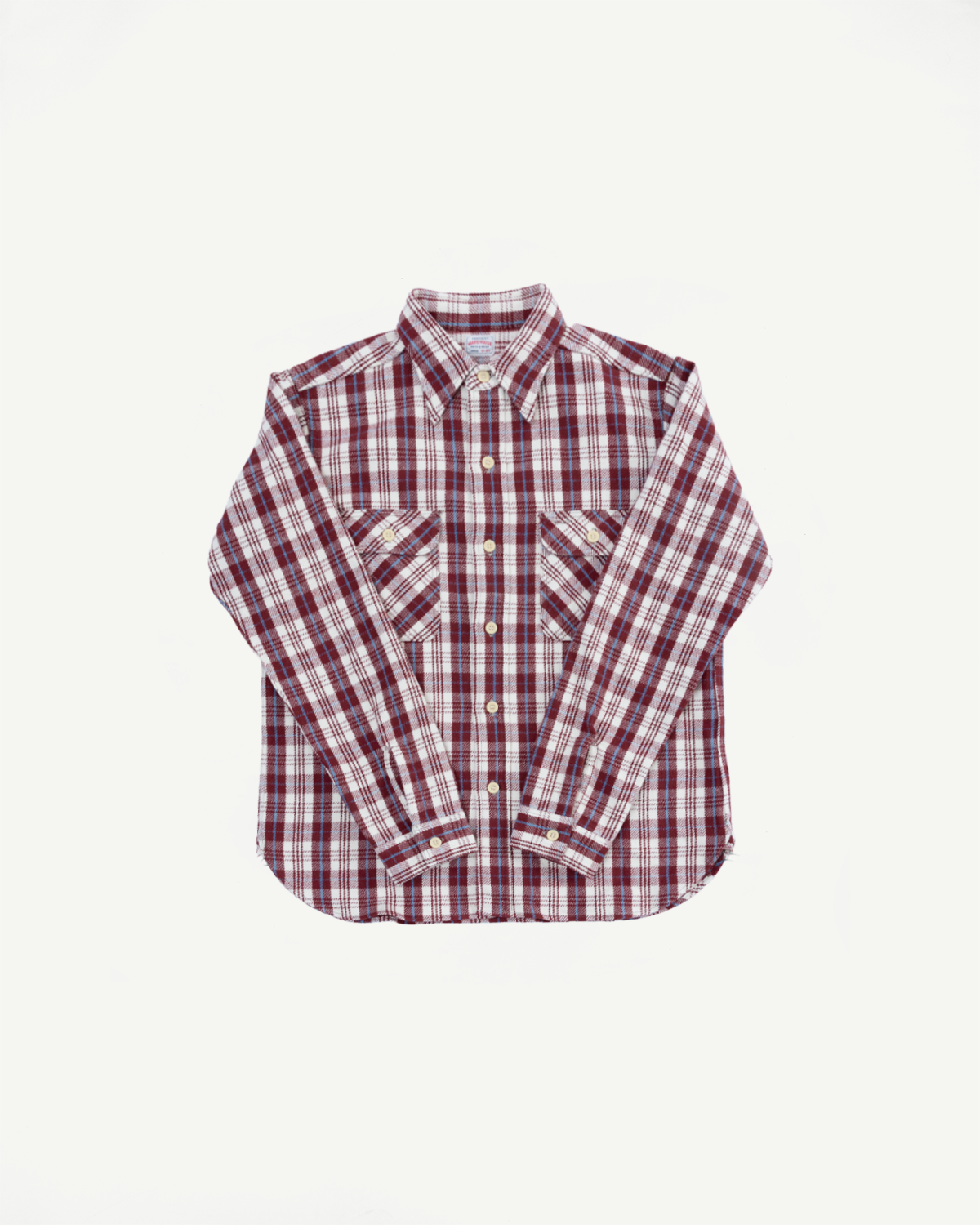 Flat lay front view of maroon plaid flannel shirt, showing chest pockets, buttons, and collar.