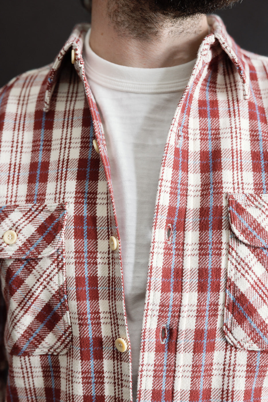Close-up of front chest on maroon plaid flannel shirt, male model 5'9