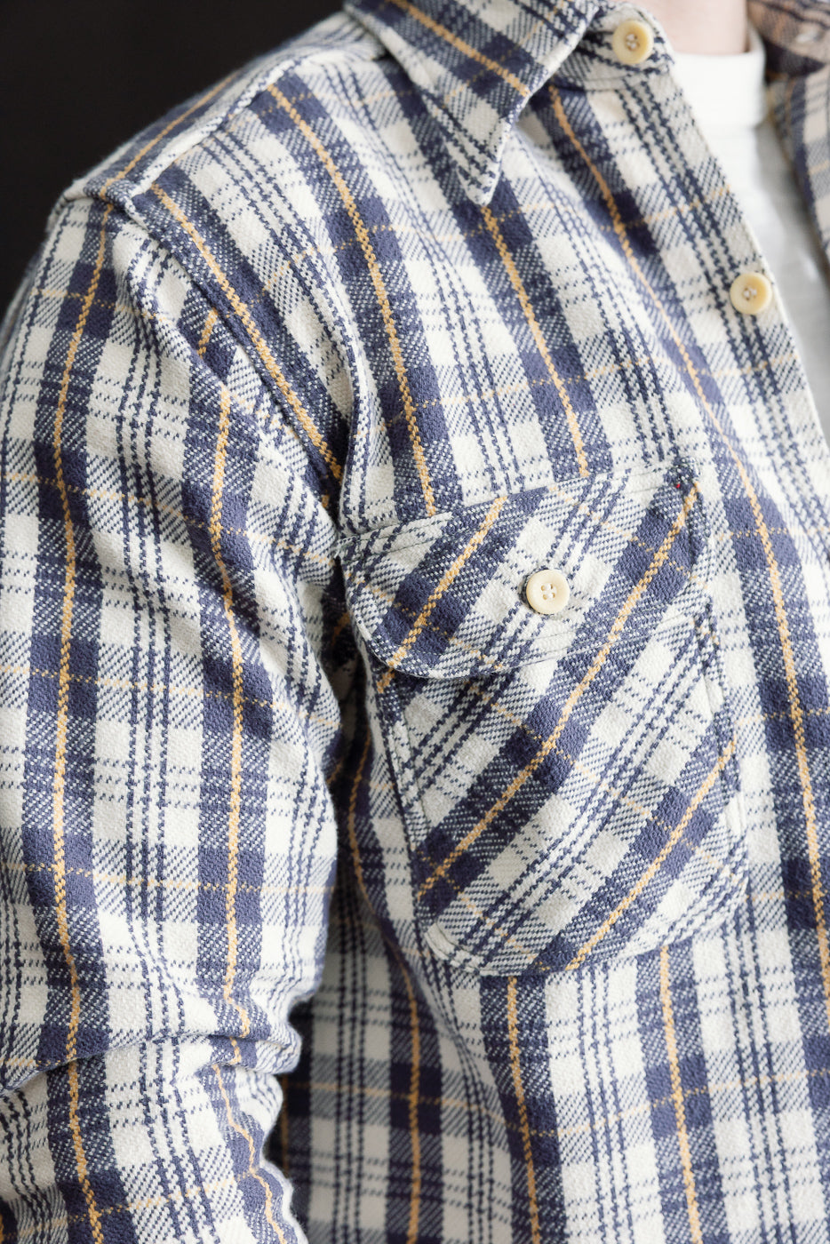 Close-up of men's navy plaid flannel shirt, front upper body and chest pocket detail, athletic male model 5'9