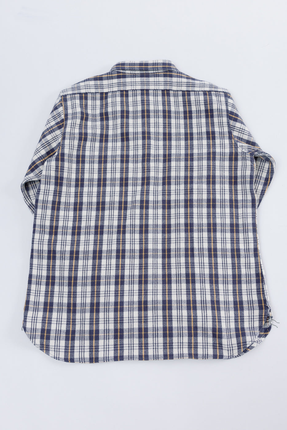 Flat lay back view of navy plaid flannel shirt, showing full back and shirt yoke detail.