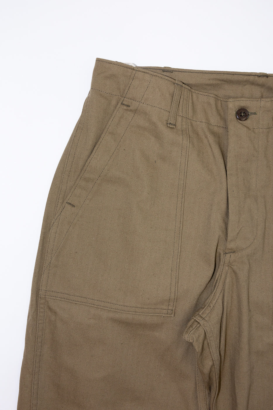 Close-up front view of olive cargo pants showing button, pockets, and fabric texture