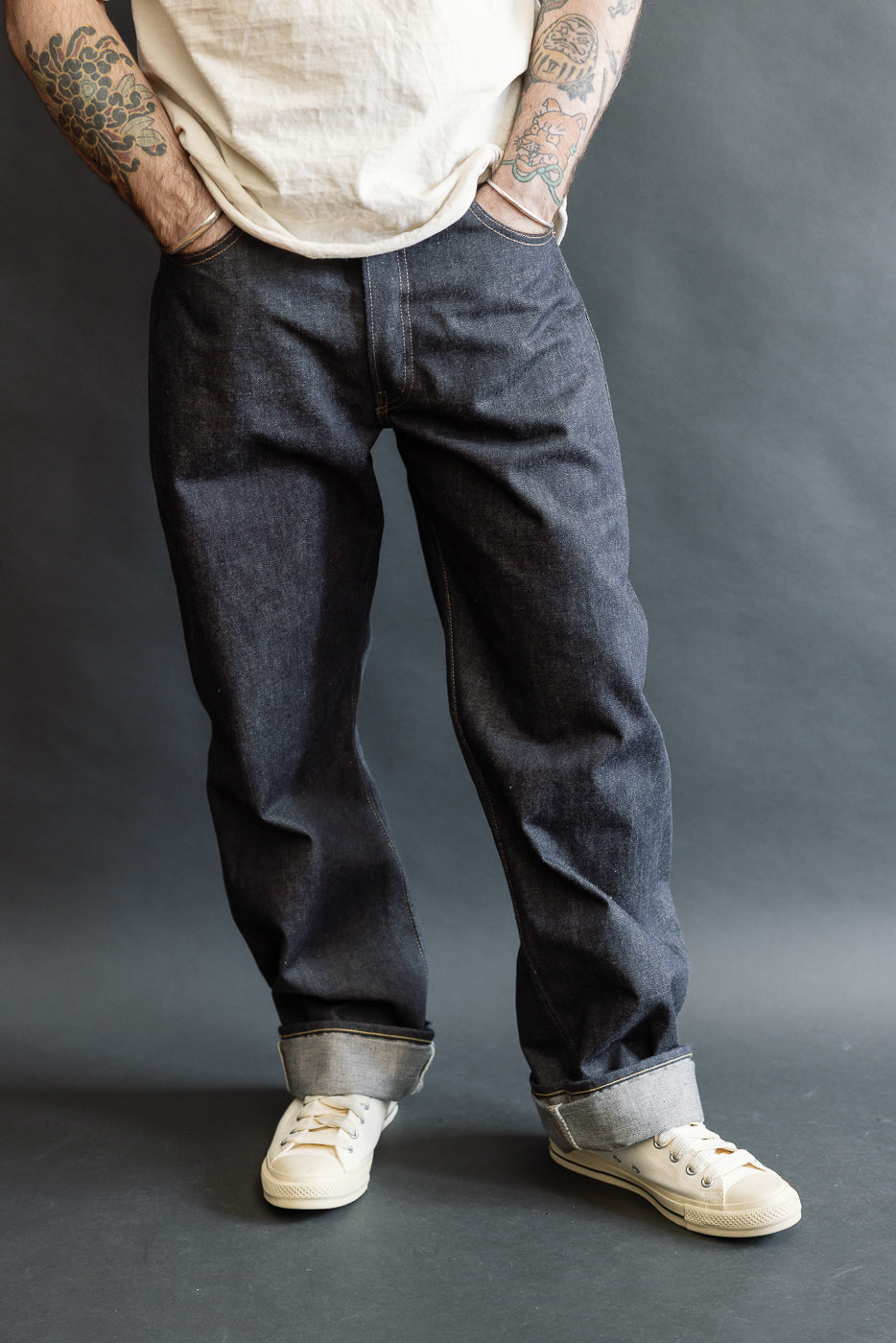 Front view, mid-length of men's selvedge jeans on 5'9
